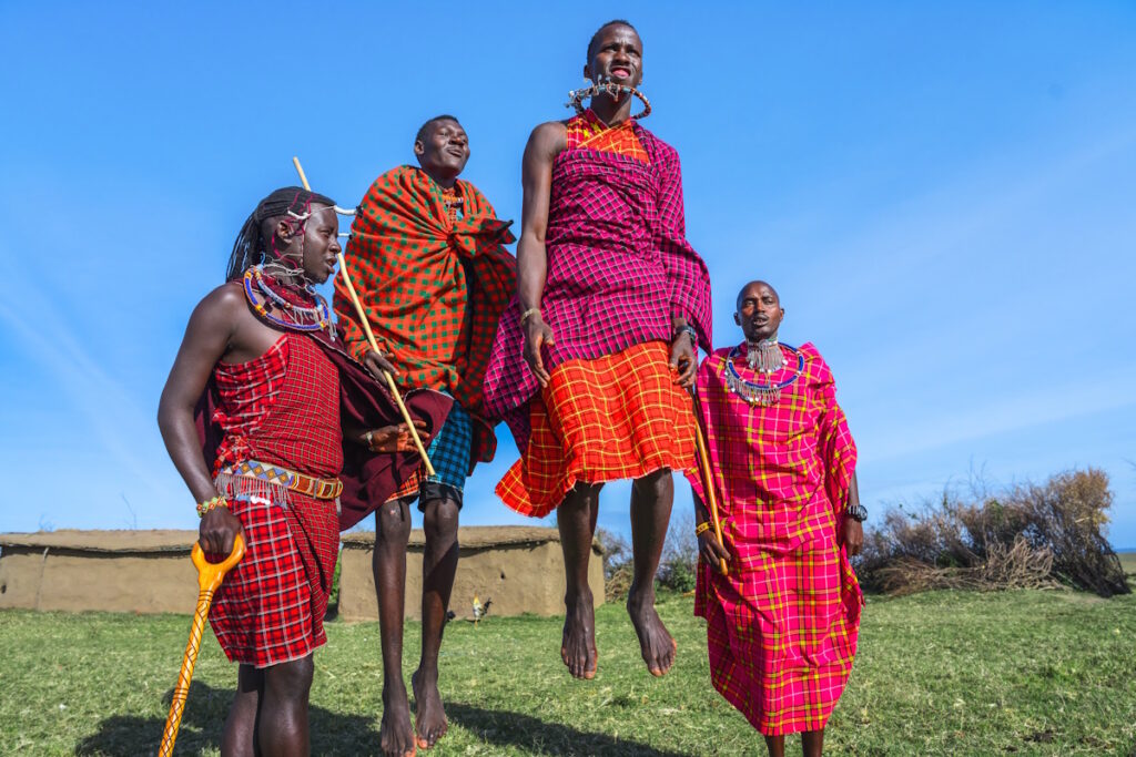 Four people performing a traditional dance
