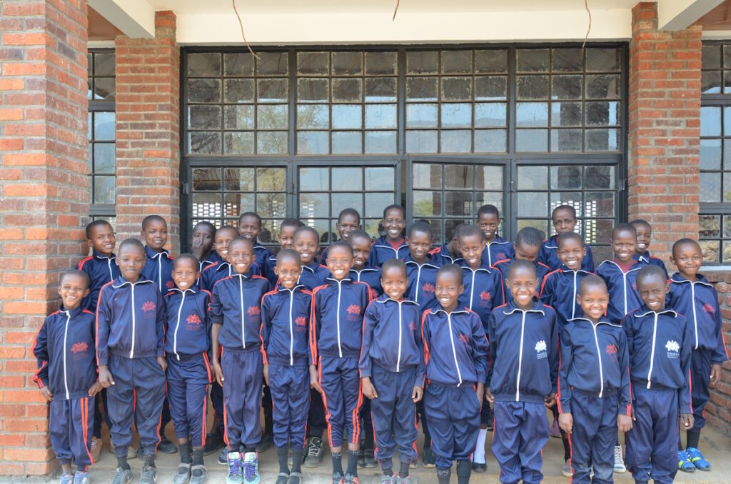 A group of young students standing in front of a building