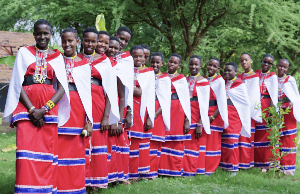 A group of people standing in a line wearing colorful traditional outfits.