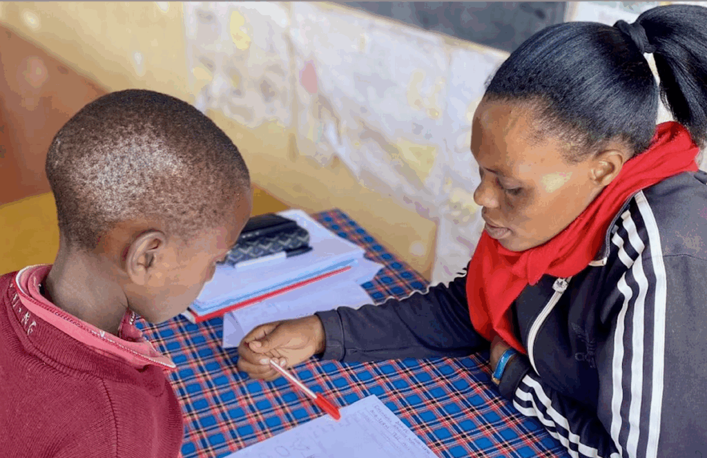 A teacher seated across from a young student at a desk