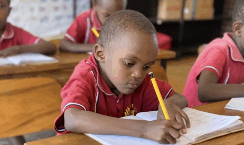 A young boy working at his desk.