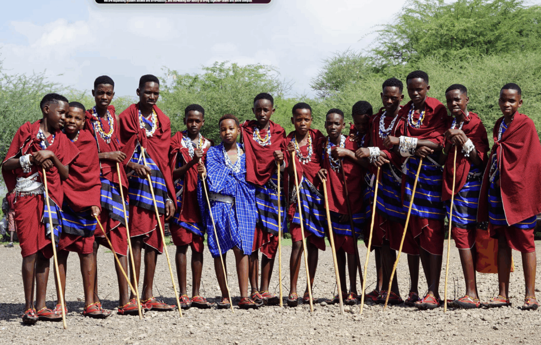 A group of students standing in a line holding staffs.